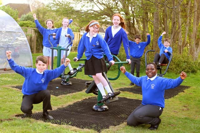 Year-six pupils on the new outdoor gym equipment fitted in the playground at Ferring Primary School. Photo by Derek Martin DM21040820a