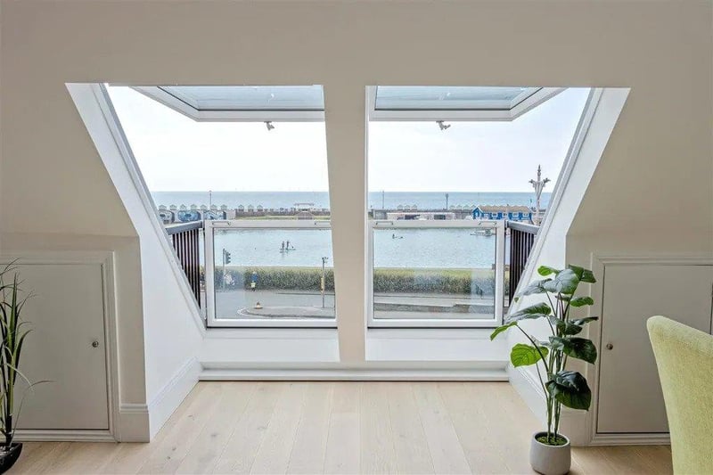 Dual balconies and large windows throughout provide stunning sea views.