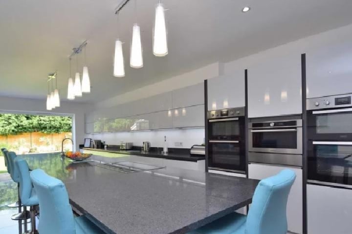 The massive futuristic kitchen and dining space features a full range of fitted wall and base units with worktops over, oversized breakfast bar, Integrated appliances and plenty of room for an ample dining table and sofa.
