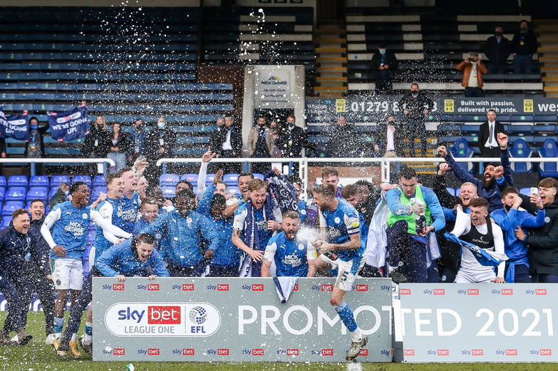 Promotion is confirmed and It’s all over and the Posh players get the bubbly out to celebrate on the pitch.