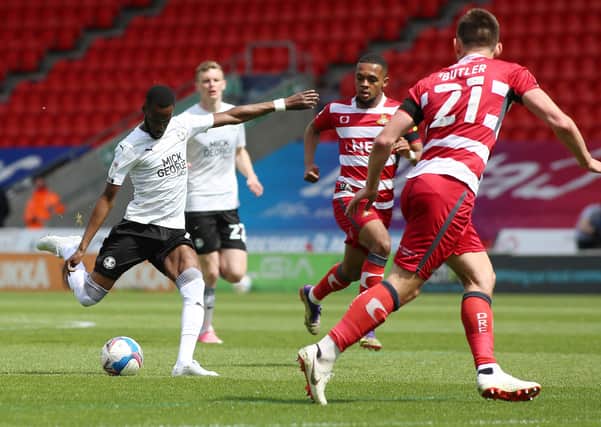 Mo Eisa of Peterborough United scores the opening goal of the game against Doncaster Rovers. Photo Joe Dent/theposh.com.