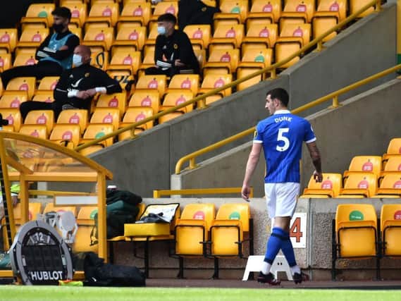 Lewis Dunk trudges off after his red card against Wolves