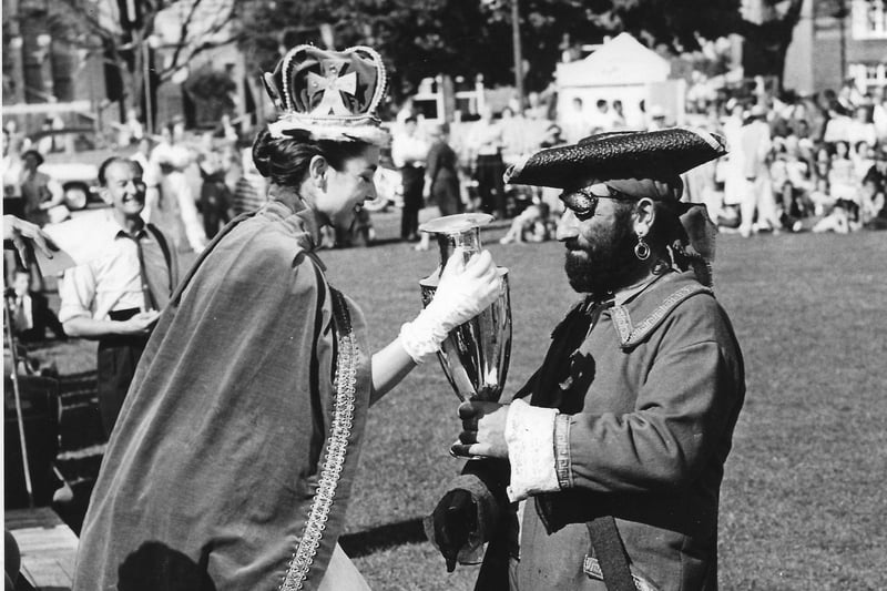 Blackbeard receiving trophy from carnival queen winning float 1961 SUS-211105-160319001