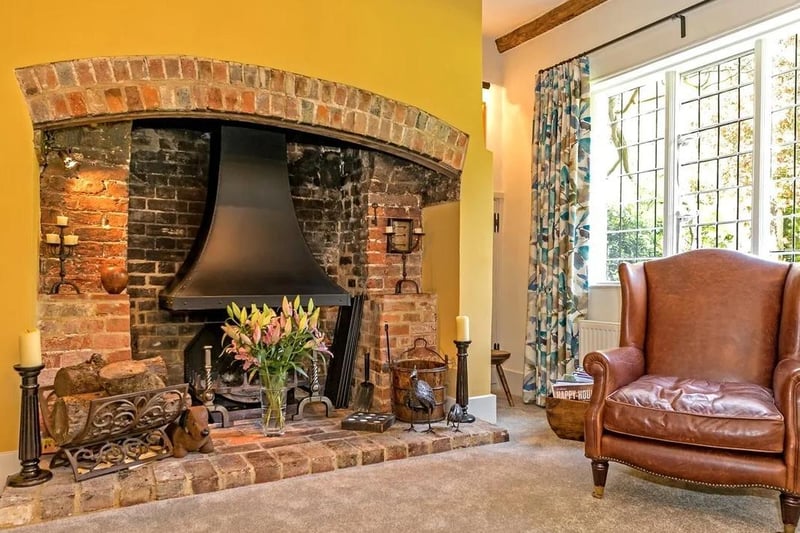 The farmhouse sitting room has an impressive inglenook fireplace