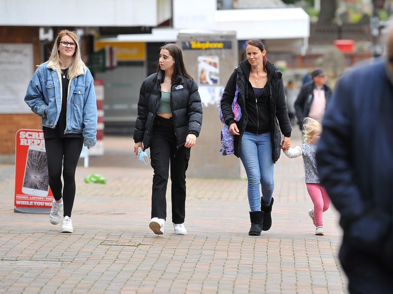 People braved the showers to visit the shops in Burgess Hill. Pic S Robards SR2105171 SUS-210517-165156001