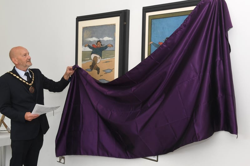 Skegness Mayor Coun Trevor Burnham unveils the paintings.