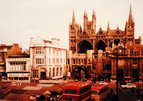 Buses, traffic and market stalls in a bustling Cathedral Square in the early 60s.