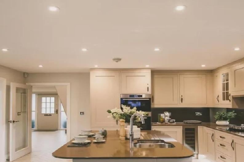 The kitchen as doubles as a dining room. It is open planned. The kitchen boasts Manor Interiors, Silestone worktops and Minoli ceramic floor tiles.