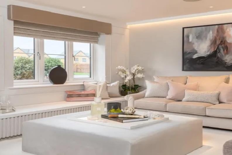 The lounge looks super comfortable and ideally spacious. The room also contains LED pelmet lighting, a bay window and French doors to the rear, leading to the private garden.