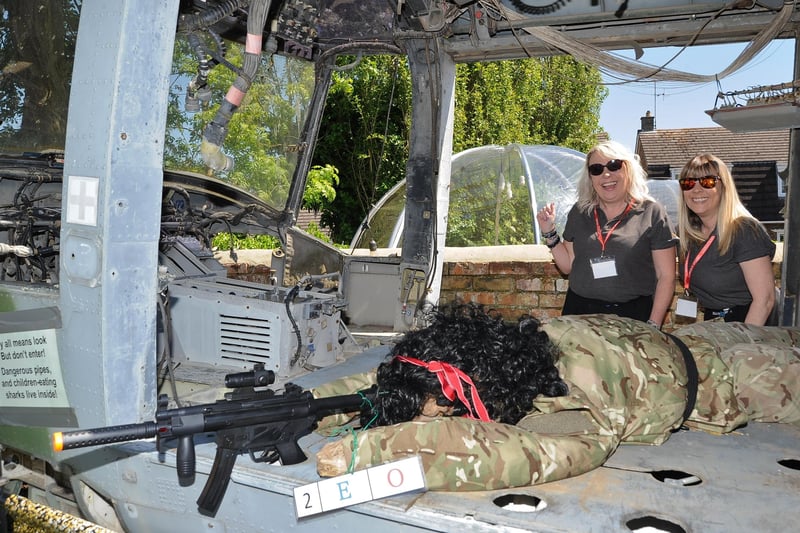 Scarecrow Festival at Werrington.   Tanya and Mandy Davis with Rambo at the Blue Bell pub helicopter. EMN-210529-155036009