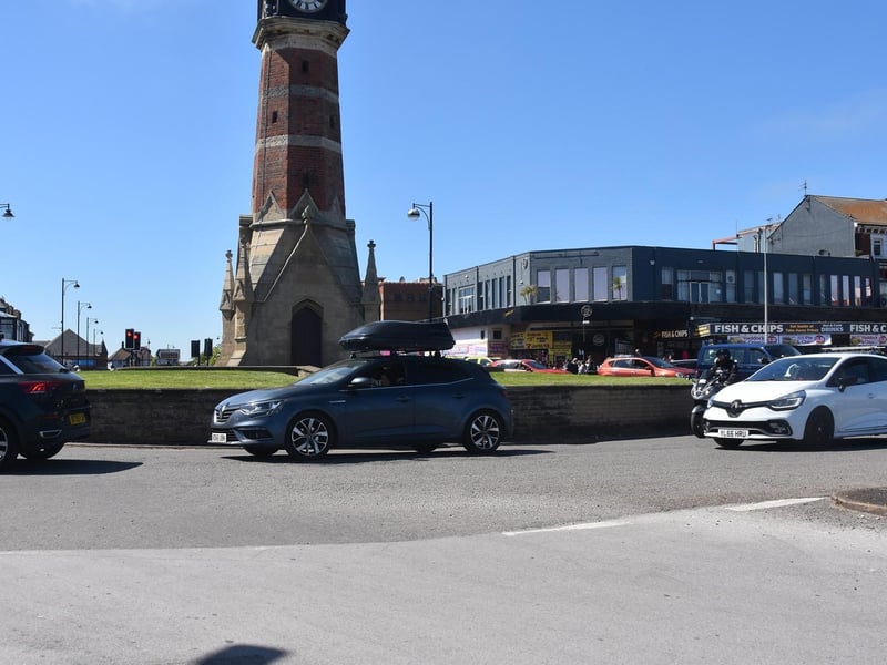 Traffic queuing for the entrance to the car park along the seafront.