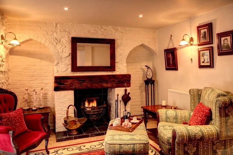 The spacious lounge and snug area with feature fireplace