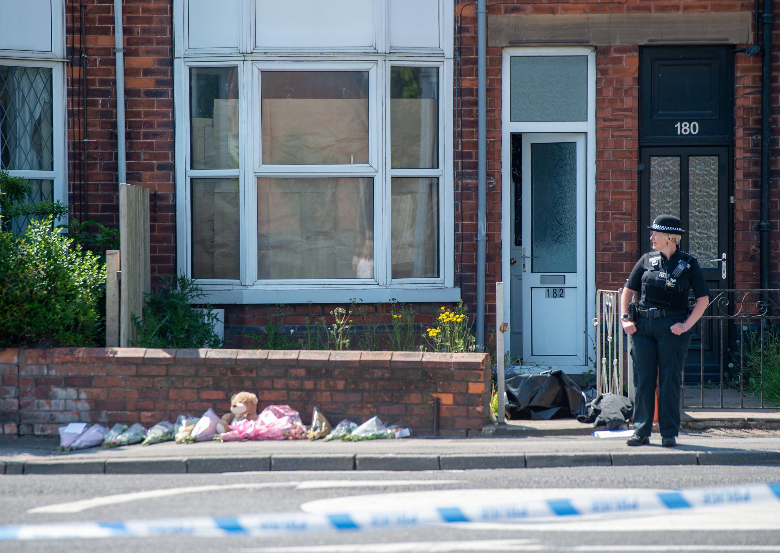 Tributes left outside the property in High Holme Road, Louth.