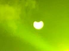 Kaz Wright had the bright idea to photograph the event through a welding mask, capturing this slightly alien but impressive snap.