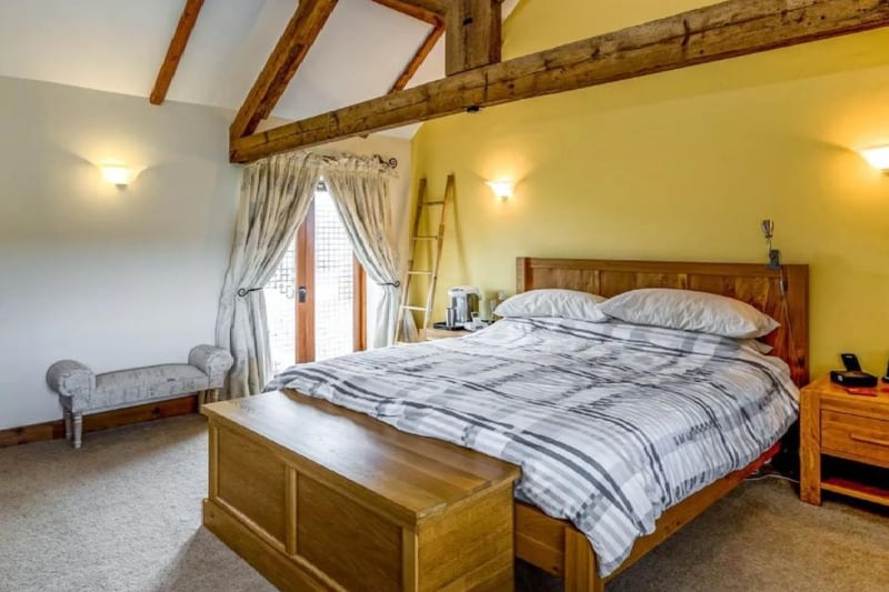 This master bedroom is once again situated in a rather spacious room. The double bed is surrounded by drawers and cabinets to contain clothing.
