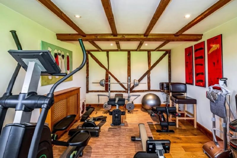 The home gym has almost everything you'll need for a work out. A rowing machine, a weight rack, cross trainer, exercise ball, and more.