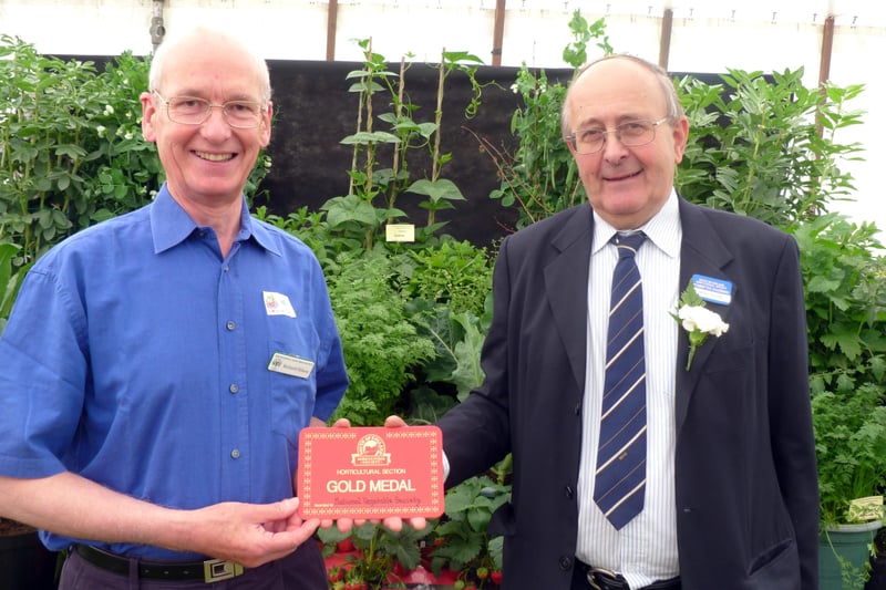 South of England Agricultural Society committee chairman Brian Jeffries presents a gold medal to Richard Hilson from the National Vegetable Society at the 2013 show. Picture: Susan King
