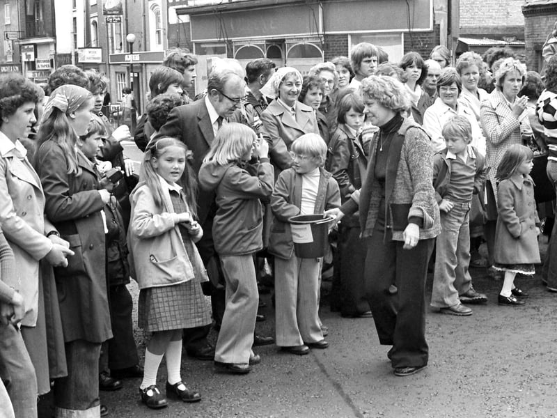 Crowds watch the floats go by