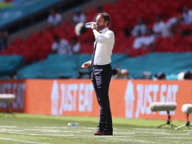 Gareth Southgate takes a drink in the searing heat at Wembley