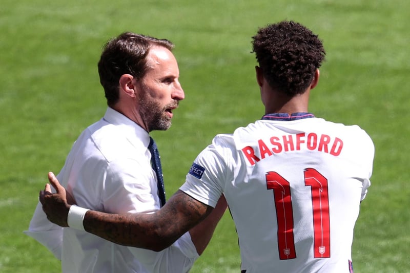 Gareth Southgate talks to Marcus Rashford before he replaces Phil Foden