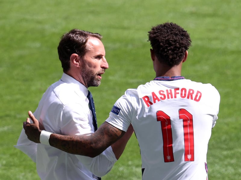 Gareth Southgate talks to Marcus Rashford before he replaces Phil Foden