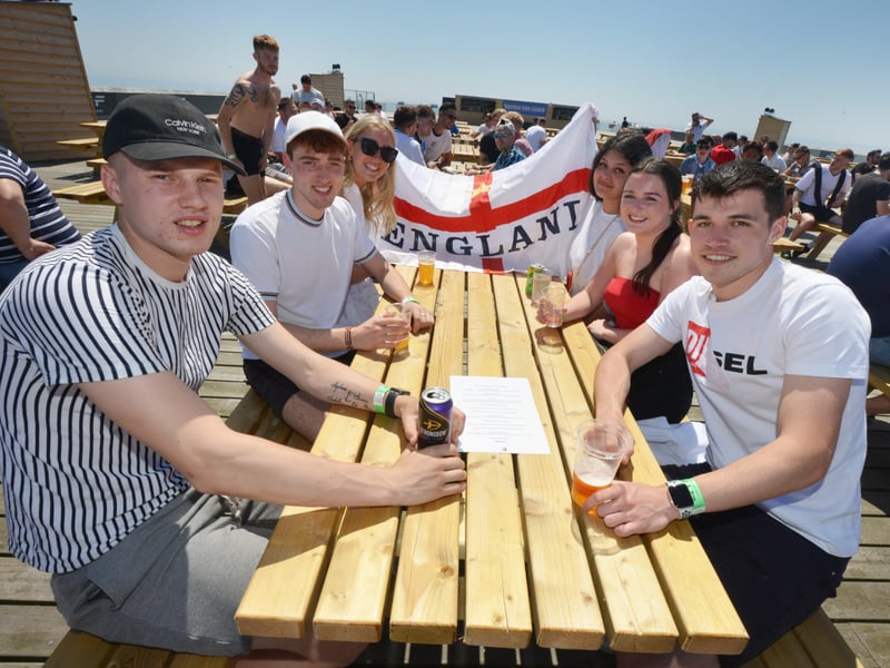 Football fans getting ready to watch England V Croatia at the Bier Garden on Hastings Pier. SUS-210614-070822001