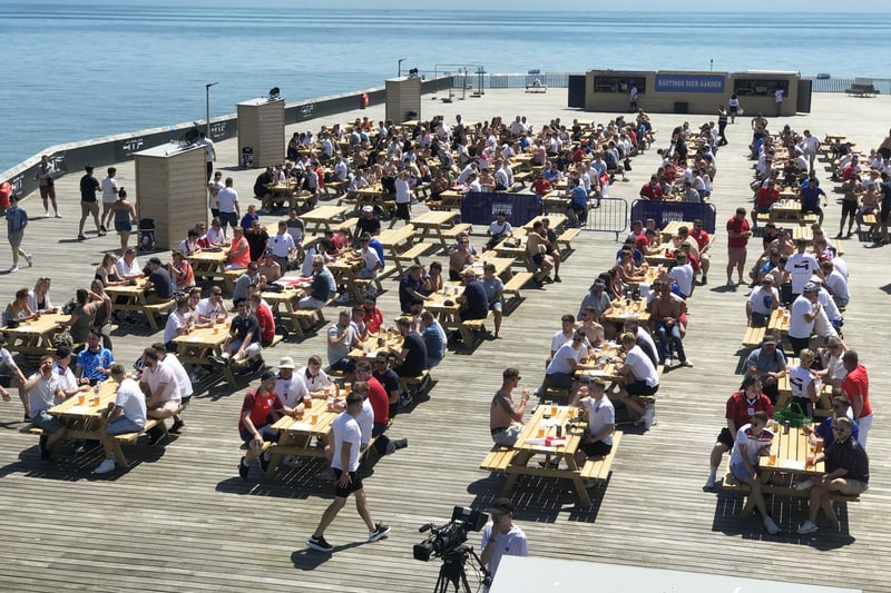 Football fans getting ready to watch England V Croatia at the Bier Garden on Hastings Pier. SUS-210614-070538001