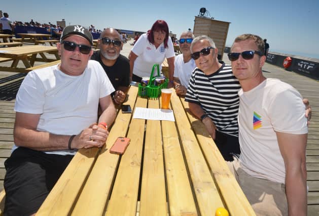 Football fans getting ready to watch England V Croatia at the Bier Garden on Hastings Pier. SUS-210614-071308001