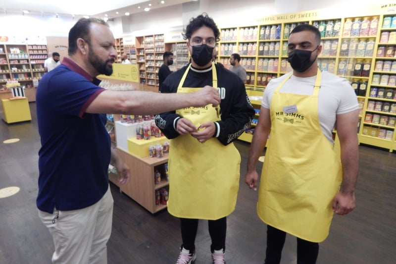 Franchisee Tanveer Ulhaq hands over store keys to sons Tahmoor and Hamza