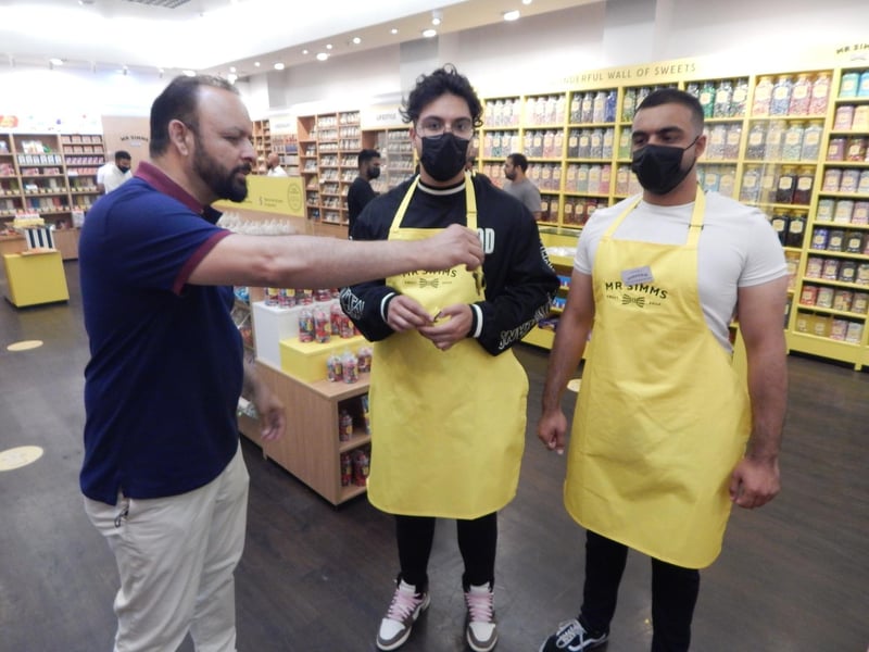 Franchisee Tanveer Ulhaq hands over store keys to sons Tahmoor and Hamza