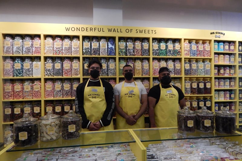 Staff in front of the wonderful wall of sweets