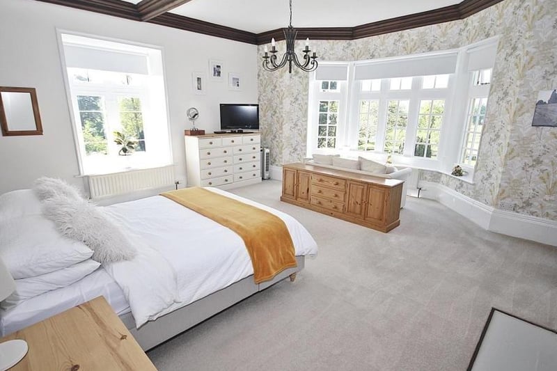 The master bedroom features a fireplace and bay windows with superb panoramic views