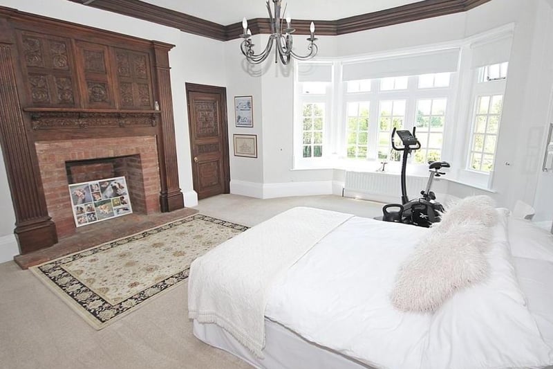 The guest room is nearly as impressive as the master bedroom, also with a fireplace and large bay window