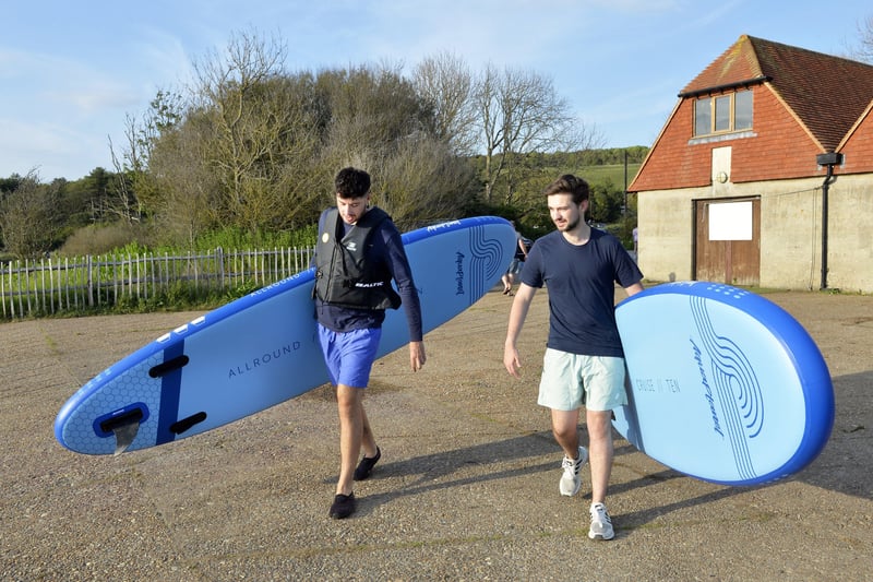 Dom and Jacob bringing the paddleboards down to the river. (Photo by Jon Rigby) SUS-210616-082853001