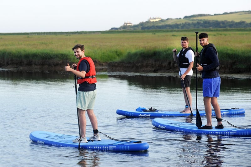 Jacob, Dom and Chris paddleboarding at Cuckmere Haven (Photo by Jon Rigby) SUS-210616-102849001