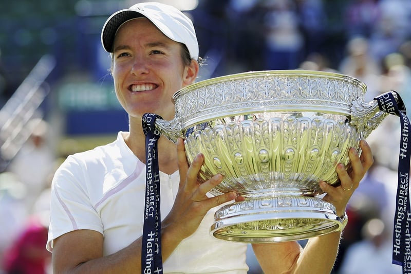 Justine Henin holds the trophy aloft after winning the tournament