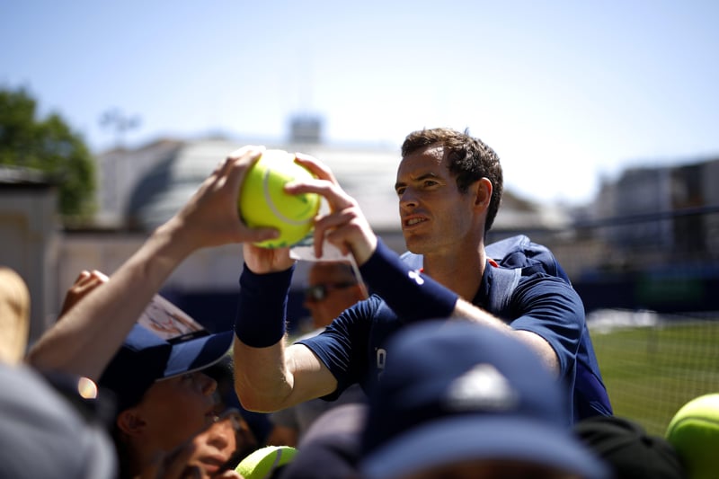 EASTBOURNE, ENGLAND - JUNE 26: Andy Murray of Great Britain signs autographs after his training session during Day Five of the Nature Valley International at Devonshire Park on June 26, 2018 in Eastbourne, United Kingdom. (Photo by Charlie Crowhurst/Getty Images for LTA) SUS-180207-102402002