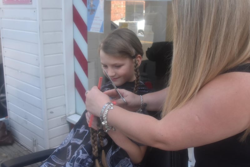 Finley's hair is braided for the Little Princess Trust to make with for children with cancer.
