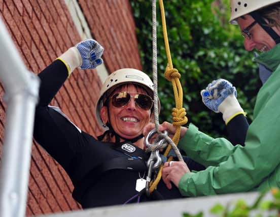 5/7/14- Charity abseil to raise money for St Michaels Hospice.  Kym Browning at the bottom  with good reason to celebrate SUS-140507-172505001
