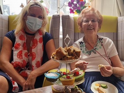 Manager Hayley Peace with Dylis Peacock enjoying cakes fit for the Queen.