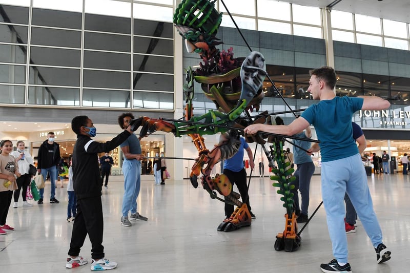 Eko, the sea monster greets some shoppers. In a dystopian future, he was washed ashore. There he encountered vulnerable Violet. These two beings tell their stories - an impactful dialogue around earth’s climate emergency told through dance, movement and masterful puppeteering.