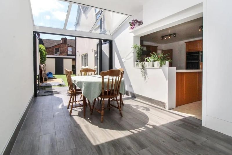 Leading from the kitchen is this breakfast room with bi-fold doors