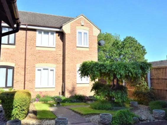 The front of the house, which has a well-kept garden