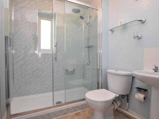 The bathroom has a walk-in shower