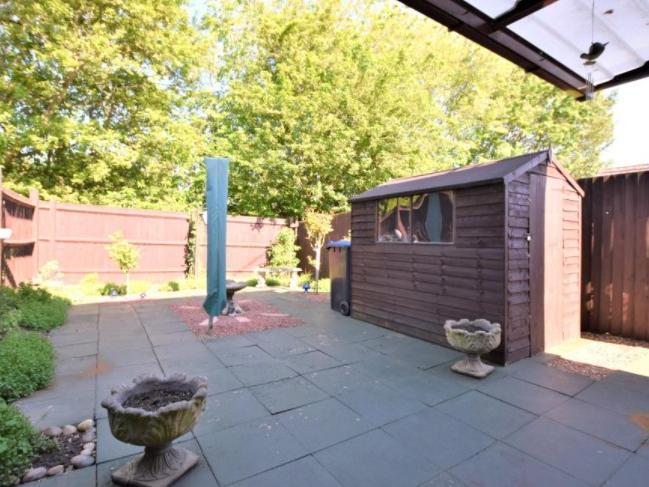 The back garden is patioed and has a good-sized shed in