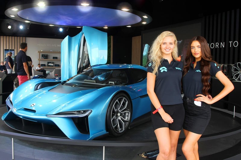 Sophie, left and Scarlett, and a Nio ep9 electric car.