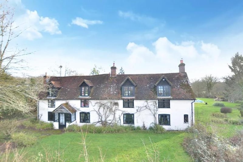 This detached Grade II listed farmhouse in West Chiltington Lane, Billingshurst, is surrounded by its own 40 acres of grounds and pastureland. 
The home has four bedrooms, stables, an outdoor riding area, large barns on concrete and a swimming pool. 
The guide price is £2,495,000