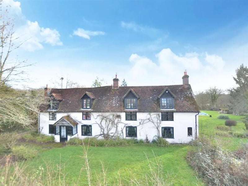 This detached Grade II listed farmhouse in West Chiltington Lane, Billingshurst, is surrounded by its own 40 acres of grounds and pastureland.
The home has four bedrooms, stables, an outdoor riding area, large barns on concrete and a swimming pool.
The guide price is £2,495,000