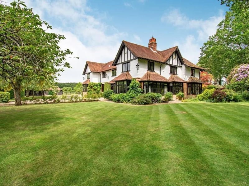 Brackenwood is an impressive family home situated in Blackhouse Road, Colgate, in the High Weald Area of Outstanding Natural Beauty.
It is believed to date from 1911, and it has been extended and improved over the years.
The seven-bedroom home has many period features and is set in 4.9 acres, enjoying a heated swimming pool, pool house, tennis court , 2 Stables, and
delightful landscaped gardens and paddocks.
The guide price is £2,450,000.
