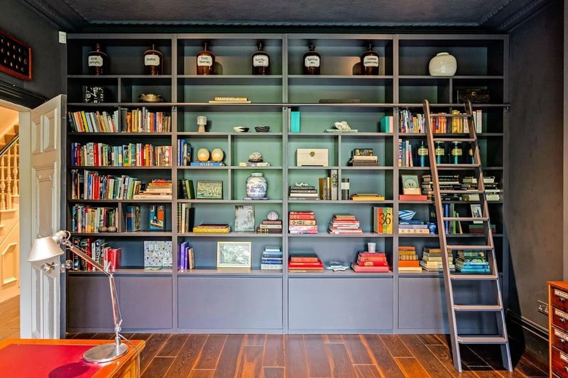 The property has floor to ceiling bookshelves with a sliding ladder.